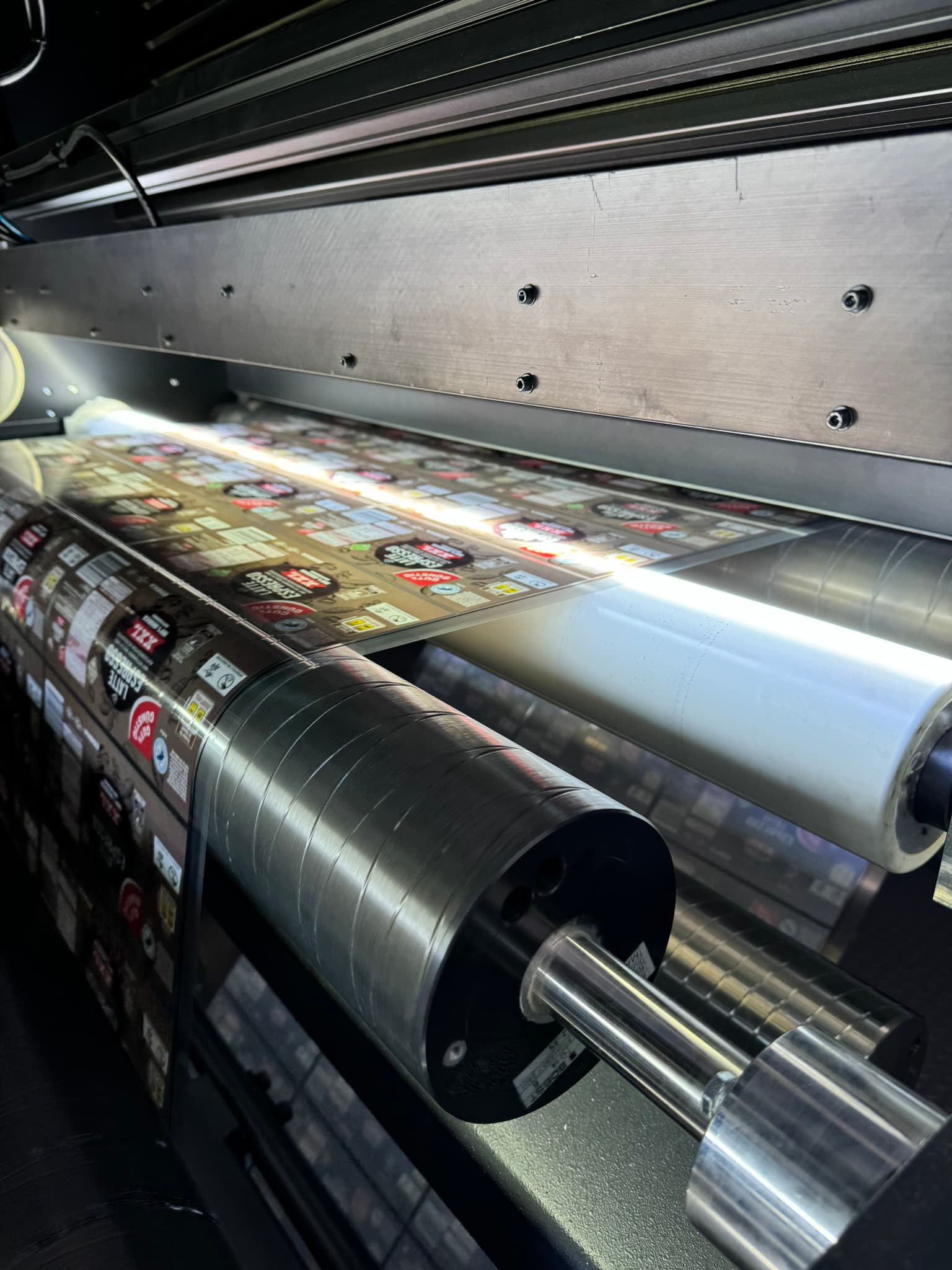 Close-up of inspected stickers being wound onto a roll